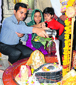 Deputy Commissioner KK Yadav offers prayers along with his family at the ancient Shiva temple, Mehna Chowk