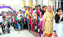 The faithful form a queue awaiting their turn at the Shiva temple in Mehna Chowk