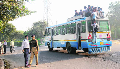 Students sit atop a Haryana Roadways bus. A large number of aspirants had come to take the SSC exam in Chandigarh on Sunday.