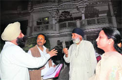 Government officials interact with residents during an awareness drive on the registration of paying guest accommodations in Mohali. 