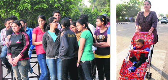 Participants wait for the chief guest during “Walk for her” walkathon; and (right) a woman participates along with her child at Sukhna Lake on Sunday.