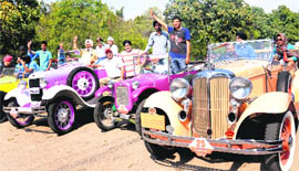Paticipants in the Classic and Vintage Car Rally with their cars at Sector 10 in Chandigarh on Sunday.