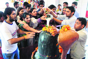 Devotees offer milk on a Shivling at a Gurgaon temple on Shivratri on Sunday.