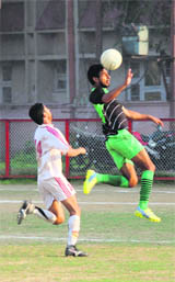 Players in action during the final match of Rajiv Gandhi Gold Cup Football Tournament at GGM Science College in Jammu.