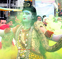 Devotees throng a temple to pay obeisance at a Shiva temple in Jalandhar on Sunday; an artiste, holding a snake and dressed as Lord Shiva, during the Maha Shivratri celebrations in Jalandhar on Sunday