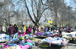 People shop at a crowded Sunday market on the main commercial street in Srinagar. 