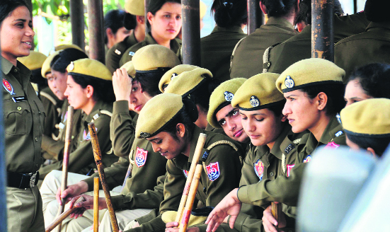 Police women sit at a bus shelter near Union Minister Manish Tewaris residence in Ludhiana where Anganwari workers held a protest on Sunday.