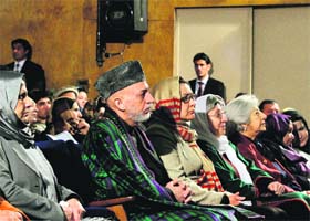 Afghan President Hamid Karzai sits among the audience prior to his nationally televised speech in Kabul on Sunday