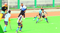 Players in action during the first quarter-final match of the All India Inter-University Hockey Championship at Guru Nanak Dev University in Amritsar on Monday. A Tribune photograph 