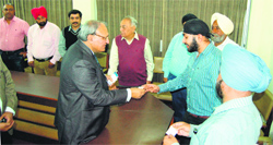 MG Sangvi (left), Chairman and Managing Director, Syndicate Bank, meets customers on his visit to Amritsar on Monday. Photo: Sameer Sehgal