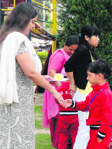 A child receives an award during the prize distribution ceremony at Kids R Kids School in Chandigarh on Monday.