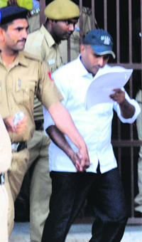 Former director of the Narcotics Control Bureau Saji Mohan comes out of a court in Chandigarh on Monday.