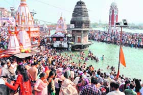 Devotees take a dip in the Ganga on Somwati Amavasya in Haridwar on Monday