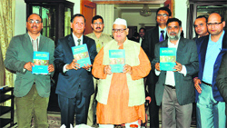 Uttarakhand Governor Aziz Qureshi releases a book written by Shriram Verma at a function in Dehradun on Monday. 