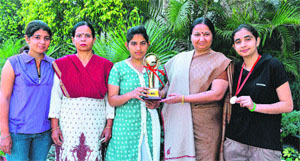The Principal of GVM Girls' College, Dr Jyoti Juneja, congratulates the winning badminton team at the college recently. 