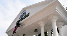 A worker paints the Assembly building in Shimla on Monday.