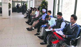 Students wait for their turn during a job fair at Himachal Pradesh University in Shimla.