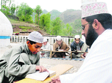 A child being taught at a madrassa. 