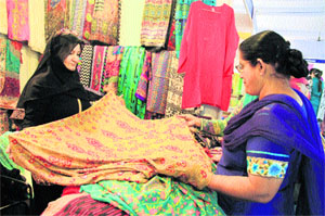 A woman visitor sees a shawl at the Indo-Pak International Expo 2013 in Jalandhar on Monday. 
