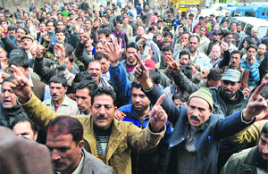 Employees of the Food and Civil Supplies Department stage a protest against the state government in Srinagar on Monday.