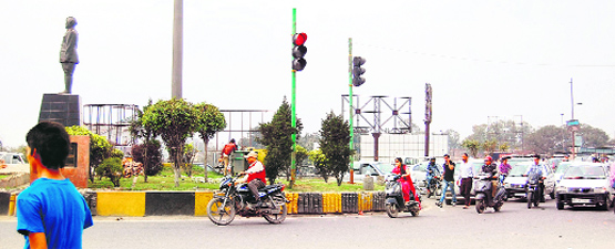 Traffic lights, installed at the Bhandari Bridge roundabout, started working in Amritsar on Tuesday. Photo: Sameer Sehgal