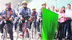 Airport director Suneel Dutt (right) and Mayor Bakshi Ram Arora (second from right) flag off the bicycle rally to Jammu at the Amritsar airport on Tuesday. A tribune photograph