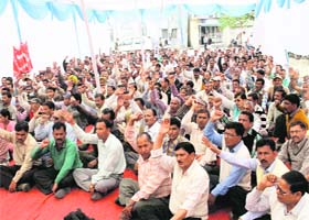 Employees of the Uttarakhand Forest Corporation hold a demonstration in Dehradun on Tuesday