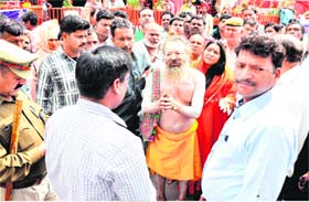 Prior to the anti-encroachment drive, Baba Dhun Giriji Maharaj, along with his followers, requests an administrative team not to carry out demolition drive at his ashram at the Ganga ghat in Haridwar on Tuesday