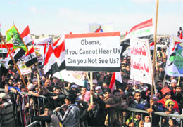 Sunni Muslims take part in an anti-government demonstration in Falluja, 50 km west of Baghdad on March 8, 2013. Thousands of Sunni Muslims protested after Friday prayers in huge rallies against Shia Iraqi Prime Minister Nuri al-Maliki, demanding that he step down.
