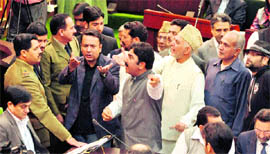 Protesting PDP legislators raise a demand for the return of the mortal remains of Parliament attack convict Afzal Guru, in Assembly on Tuesday.