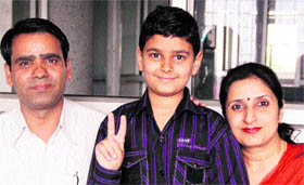 Arnav Anand, a class III student of Apeejay School, who has topped Punjab in the NSTSE examination, with his parents in Jalandhar on Tuesday.