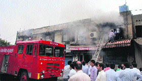 A fire tender douses flames at the National Insurance Company office in Kapurthala on Tuesday.
