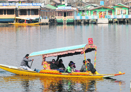 Tourists enjoy ride on a shikara on the Dal Lake in Srinagar on Tuesday.