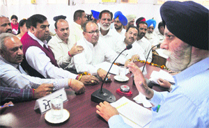Congress councillors and MLAs argue with Mayor Harcharan Singh Gohalwaria during a meeting of the MC in Ludhiana on Tuesday. 