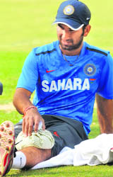 Cheteshwar Pujara nurses his injury. 