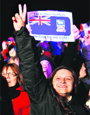 Falkland islanders react after hearing the results of the referendum in Stanley on Monday. 