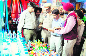 A team of Health Department inspects food items at a shop in Amritsar bus stand on Wednesday.