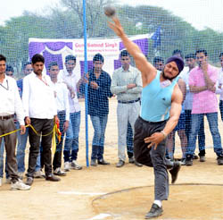 An athlete takes part in the shotput competition