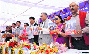 Chief Minister Vijay Bahuguna, along with his Cabinet colleagues, releases a souvenir in Dehradun on Wednesday. 