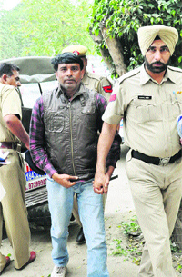 Ravinder, a proclaimed offender (PO) and brother of former minister Meena Mandal, being produced in a court in Karnal on Wednesday. 