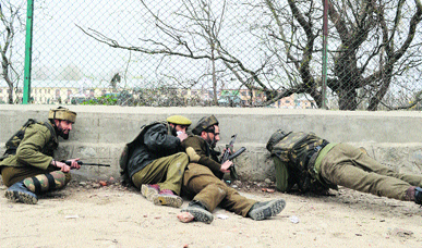 CRPF men take position outside their camp during the encounter in Bemina on the outskirts of Srinagar on Wednesday.