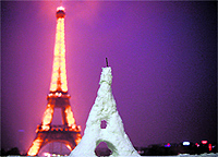 Snowy Replica: A replica of the Eiffel Tower made of snow in front of the Eiffel Tower in Paris