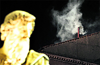 White smoke rises from the chimney on the roof of Sistine Chapel, signalling new Pope's election