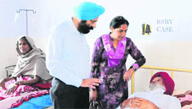 Deputy Medical Commissioner Dr Prabhdeep Kaur and senior medical officer Balbir Singh Dhillon speak to a patient at the Civil Hospital on Thursday.