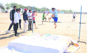 An athlete clears the hurdle in the high jump at the GKU sports meet.