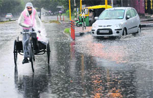 A rickshaw-puller braves rain