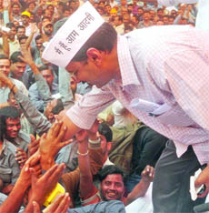 Aam Aadmi Party (AAP) national convenor Arvind Kejriwal reaches out to the auto drivers during a protest rally for their rights at Ramlila Grounds in New Delhi on Thursday.