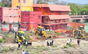 An illegally built temple-cum ashram being demolished in Haridwar on Thursday.