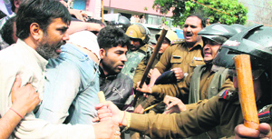 Contractual employees of the Electricity Department jostle with policemen during their protest in front of the state Assembly building in Dehradun on Thursday.