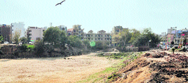 A view of buildings coming up along the pond of Sukhrali village near IFFCO chowk in Gurgaon. Tribune photo: Sayeed Ahmed